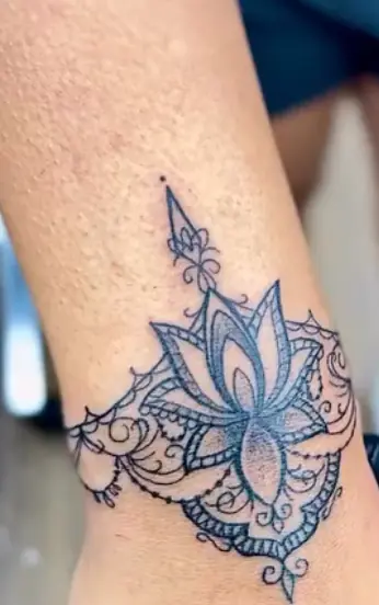 Fine-line ornamental floral tattoo