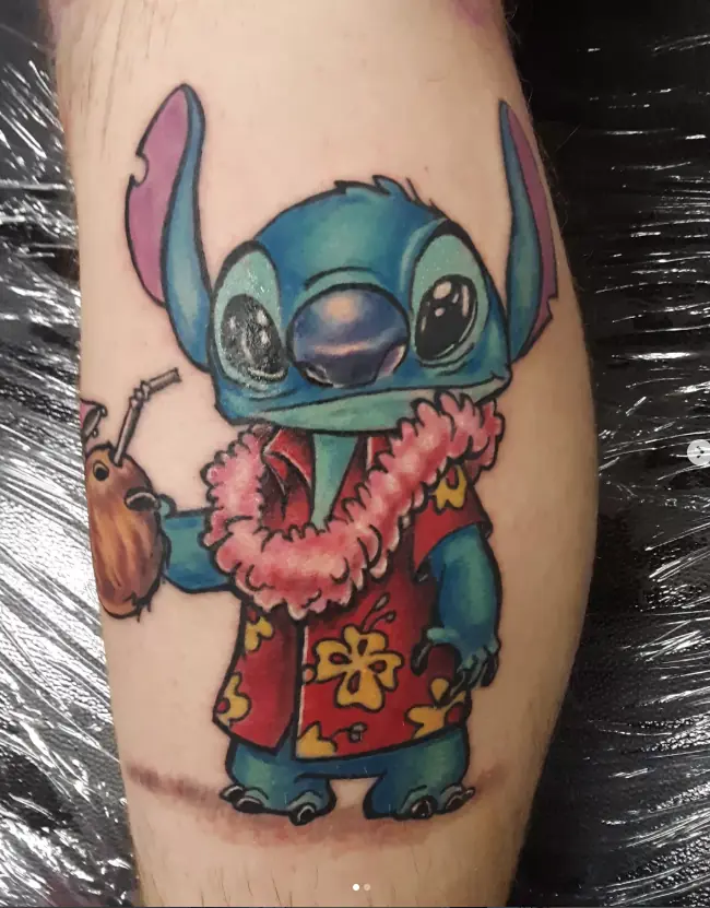 Color tattoo of Stitch wearing a flower lei
