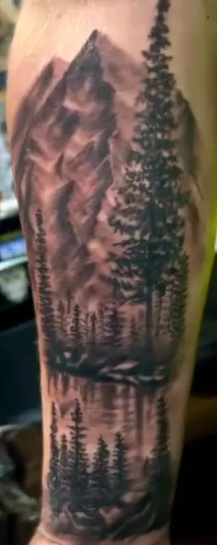 Black and gray forest and mountain landscape tattoo