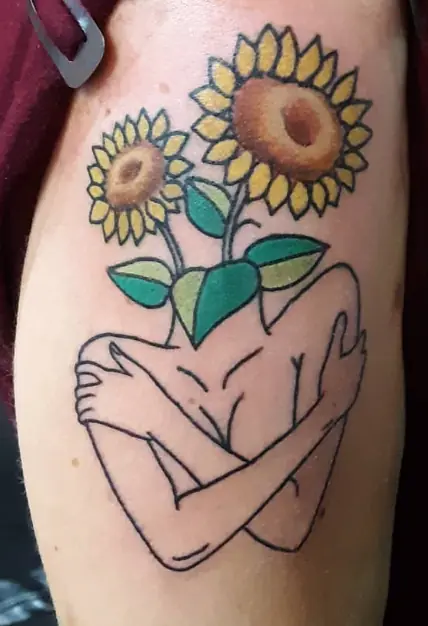 Sunflower tattoo held by an abstract outlined figure